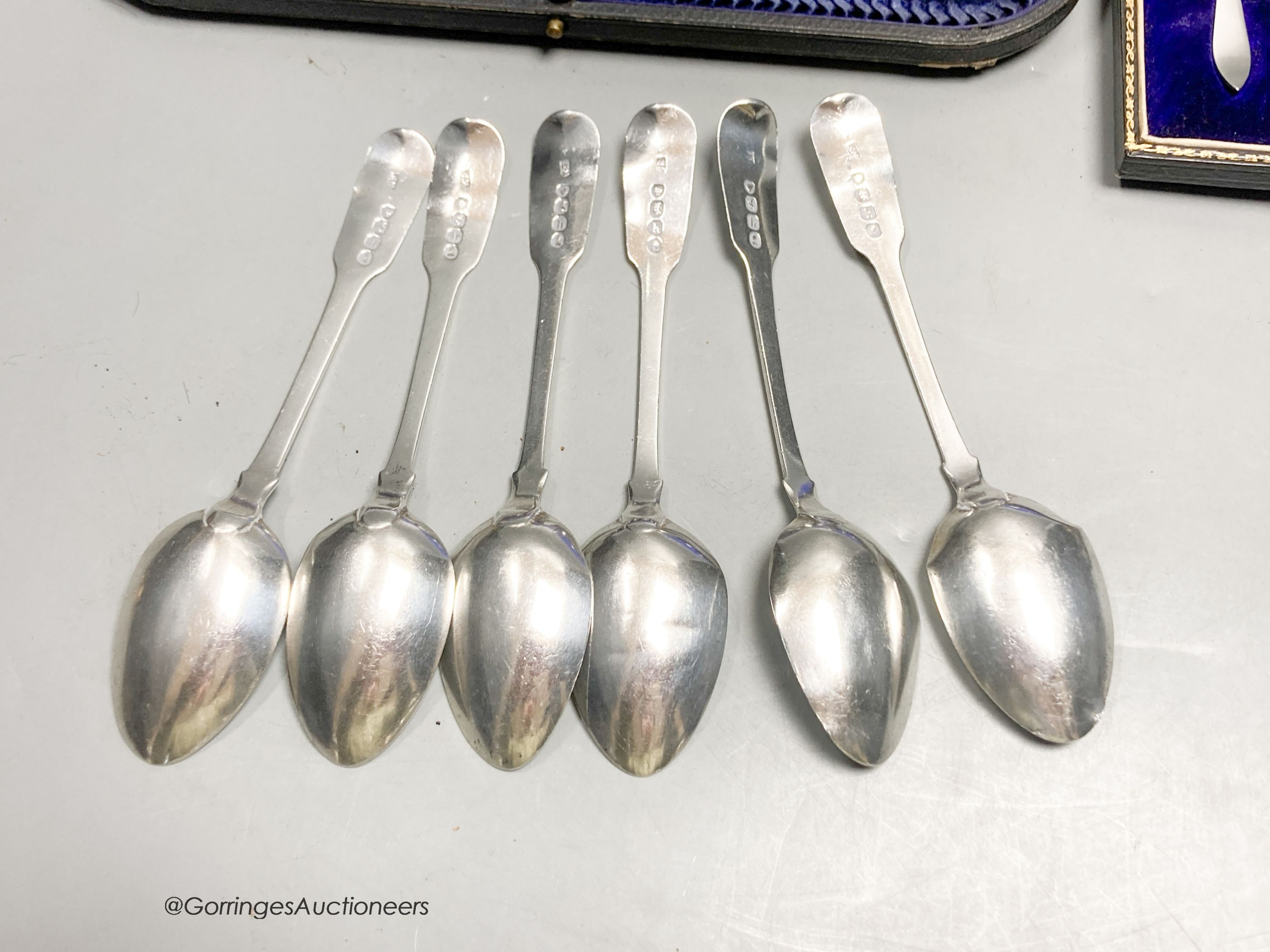 A set of six George IV silver fiddle pattern teaspoons, London, 1823, a later cased set of six silver coffee spoons and a cased mother of pearl handled silver toasting fork.